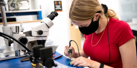 Student soldering in the Maker-E