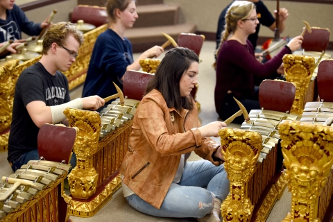 Students play metallophones in classroom.