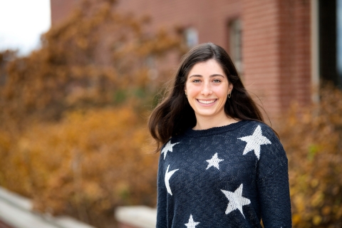 Genevieve Block &#039;22 in a blue sweater with white stars.