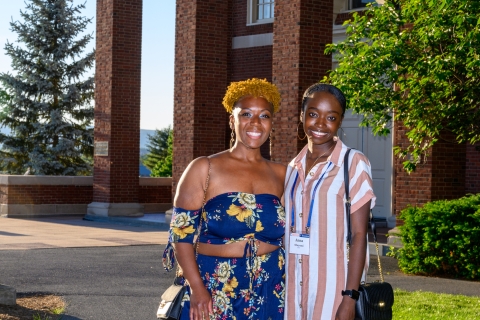 Two women smiling in the quad