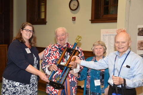 Elizabeth Richer presenting members of the class of 1965, including Forrest Chilton &#039;65, P&#039;88, GP&#039;22 and Valerie (Silbernagel) Chilton &#039;65, P&#039;88, GP&#039;22, receiving the Orange and Blue Spirit Award for the most notable overall Reunion spirit.