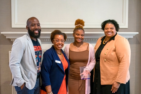 Marcus Scales, director of multicultural student services; Vernese Edghill-Walden &#039;87, vice president of equity &amp; inclusive excellence; Endia Scales &#039;24, award recipient; and Denelle Brown, associate dean of students, diversity &amp; inclusion stand and smile while Endia holds an award.