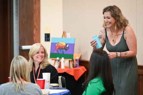 Alumni receive instructions during the Paint 'n Sip session.