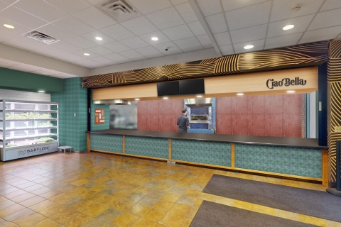 The counter Ciao Bella eatery in the Bison Cafe is to the center right. A lighted cabinet displaying microgreens with a sign, Babylon Microgreens is to the left.