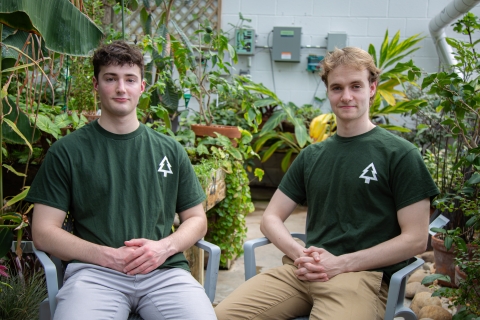 Ben Suit '27 (L) and Zack Yardley '25 (R) - Third Place $2,500 -  Forevergreen, sitting on chairs in front of plants