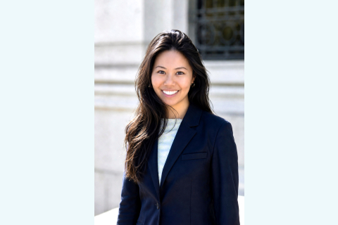 Vivian Kuang smiles wearing a dark blazer