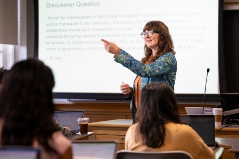Professor Katharine McCabe, women&#039;s &amp; gender studies, points to an unseen student while teaching a class