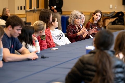 Jane Fonda sits at a table and speaks with Bucknell students.