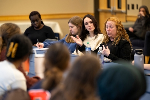 Author Jodi Picoult sits at a table with Bucknell students and actively engages in conversation with them.
