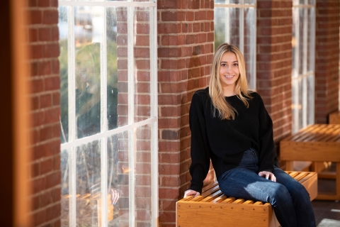 Allie Neugeboren sits in front of a window.