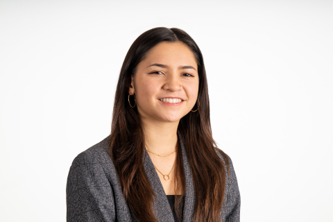 Angelina Santos smiles against a white backdrop