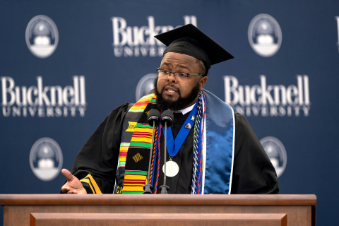 Jawaad "KJ" Benson speaks while standing at a podium