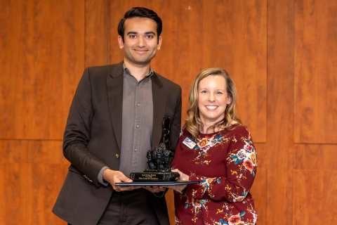 Farhaj Shahid '26 accepts an award from Emily Dietrich