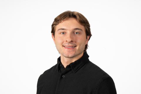 Quinn Smith smiles against a white backdrop