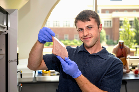 Tanner Tighelaar holds up a silicon mold