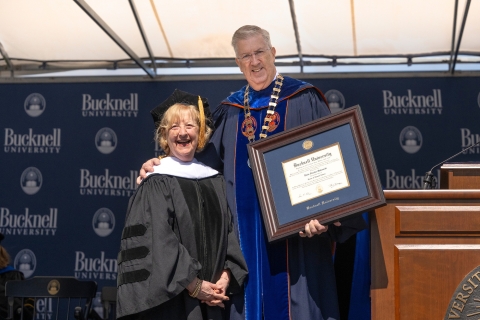 President John Bravman presents Doris Malesardi S’45 with an honorary doctor of humane letters degree.