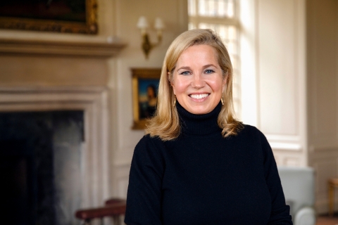 Jessica Livingston smiles in front of a fireplace