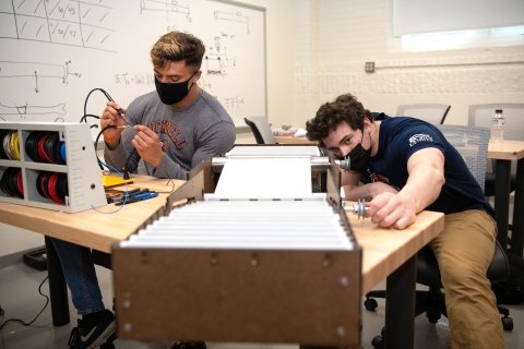 Mechanical engineering majors Michael Bortolot &#039;21 and Nate Romanowski &#039;21 assemble their prototype sanitizing device
