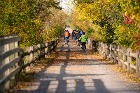 Family bike riders on an old railroad trail. 