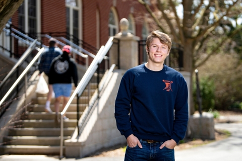 Philip Onffroy poses outside the entrance to Dana Engineering Building