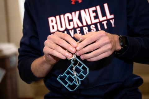 A student holds a B-shaped cookie cutter