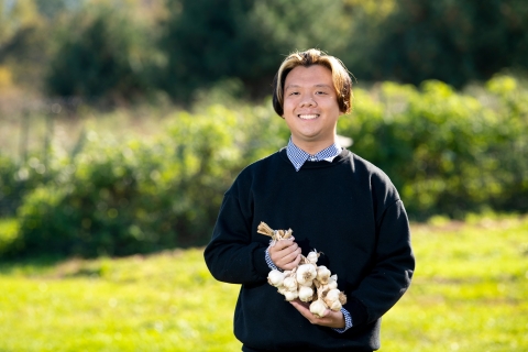 Sam Pring '23 holds garlic plant