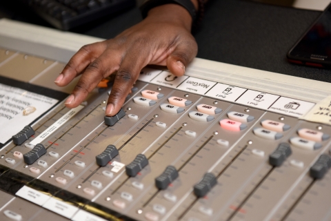 Person making a change to a sound board. 