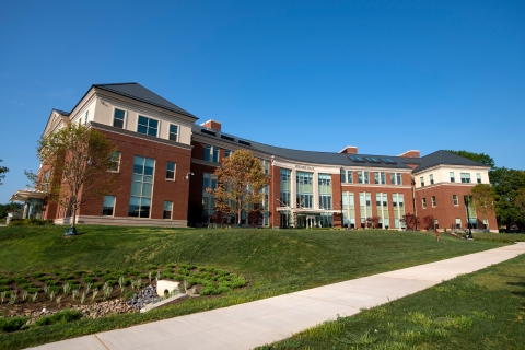 Exterior of the building Holmes Hall on a blue sky day.