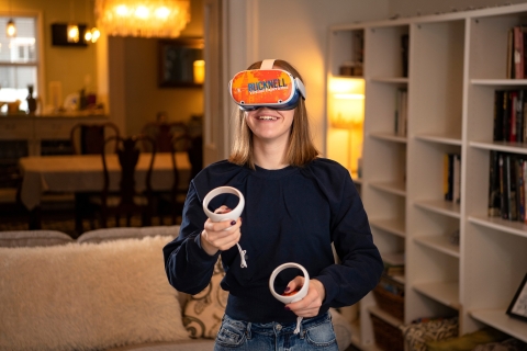 Student wears Bucknell-branded Oculus headset