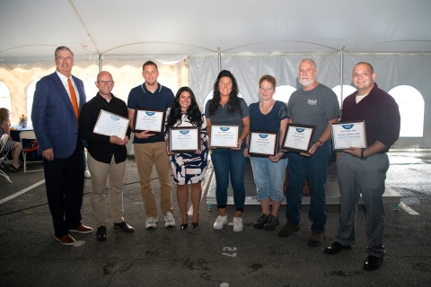 Award winners pose with their awards at the Annual Campus Picnic with President John Bravman