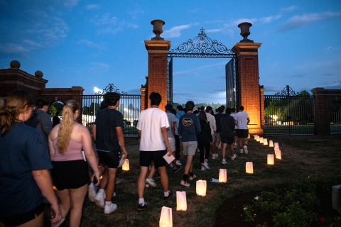 Students enter the Christy Matthewson Gates at twilight