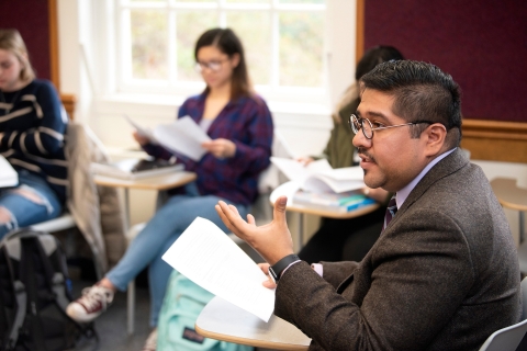 Obed Lira sitting with students