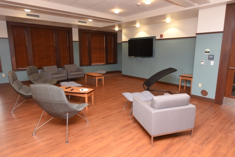 A furnished recreation room inside a residence hall