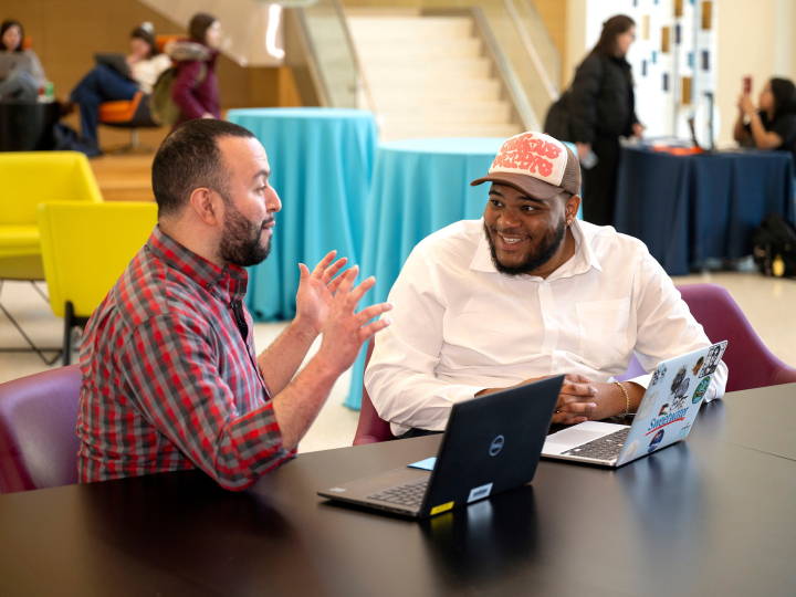 Tony Gomez and Kenneth Scott Jr. sit in Holmes Hall and talk