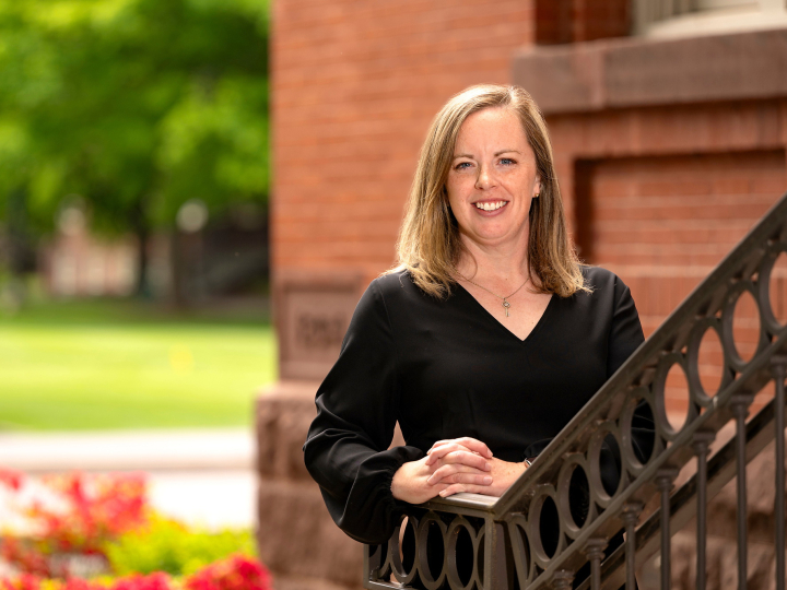 Lauren Baillie smiles on the steps of the Carnegie building at Bucknell.