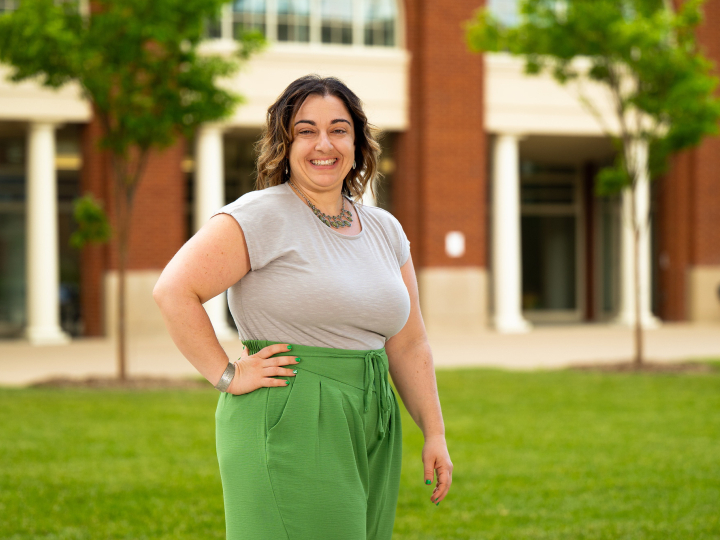 Vanessa Massaro stands outside with one hand on her hip