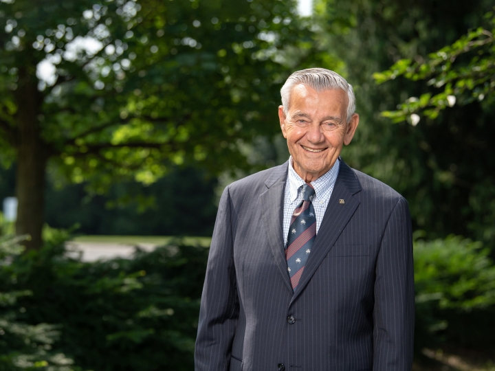 Michael Pascucci poses in front of a wooded background