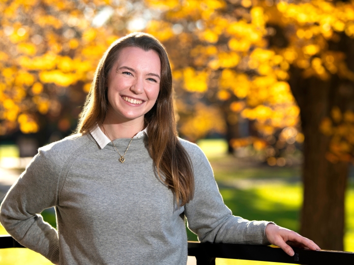 A student stands outside in the fall on Bucknell&#039;s campus