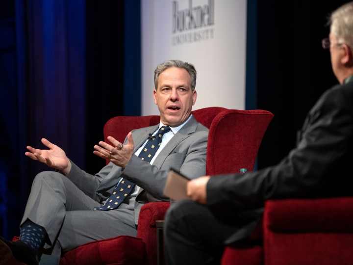 Jake Tapper speaks on stage at the Bucknell Forum