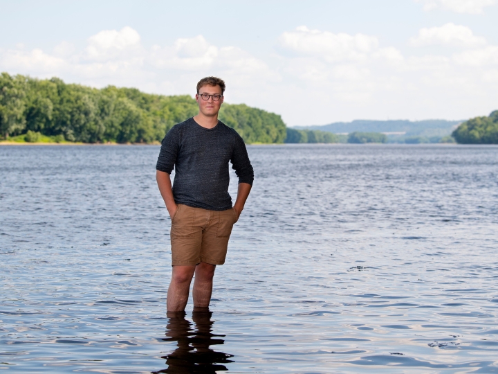 Kit Jackson stands ankle deep in the Susquehanna River