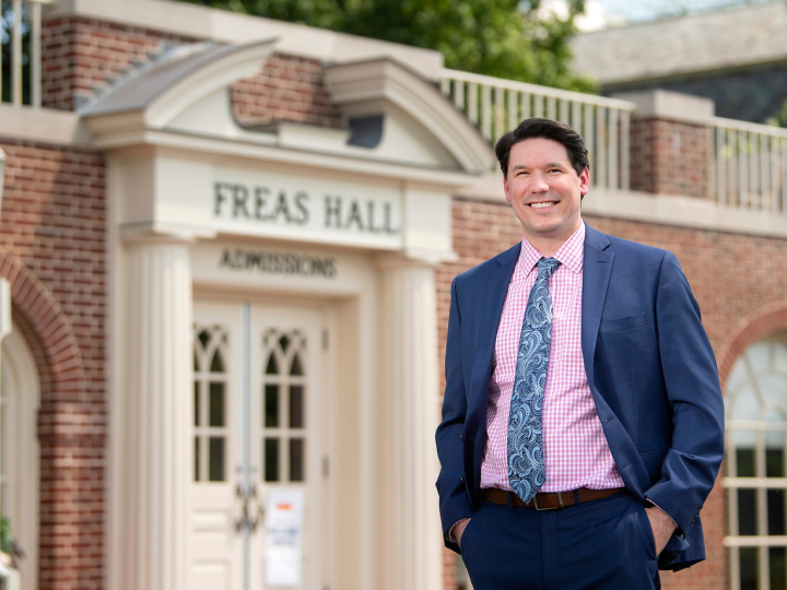 Kevin Mathes in front of Office of Admissions