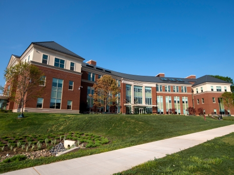 Exterior of the building Holmes Hall on a blue sky day