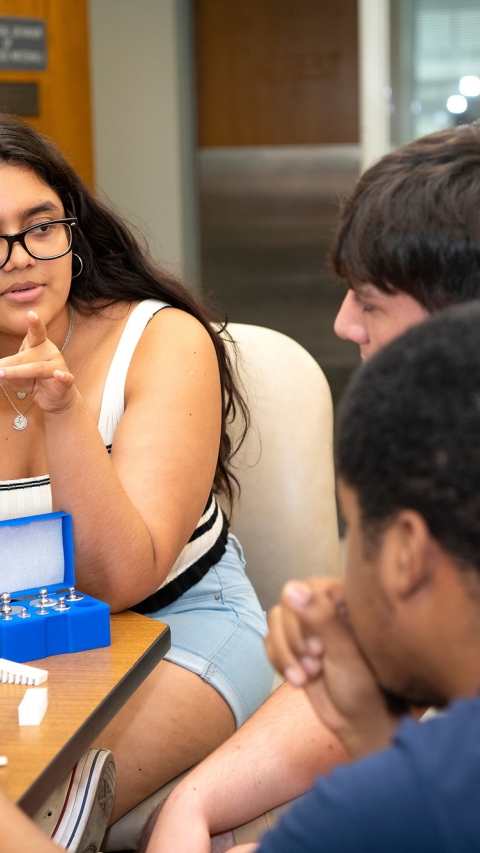 Student displays a 3D-printed spine to collaborators
