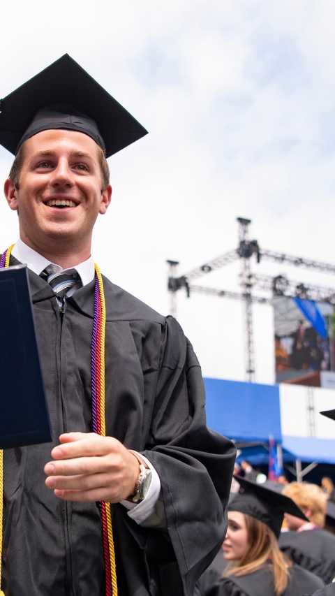 Student with diploma at commencement