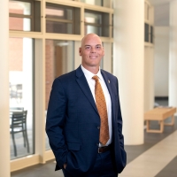 Portrait of Brad Putman in a suit inside Academic East