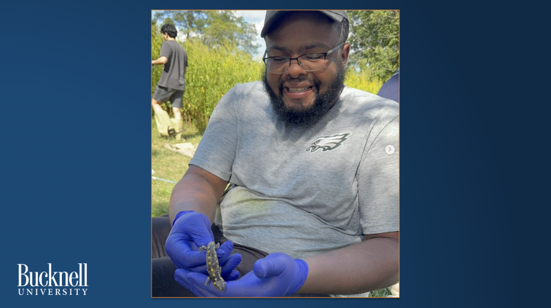 Student Jawaad Benson holds a salamander