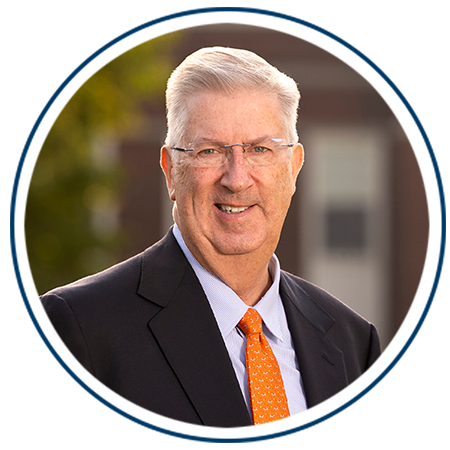 A circular portrait of President John Bravman 