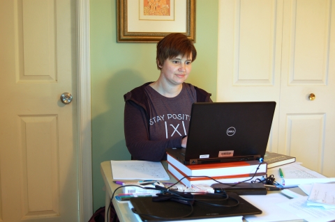 Professor Sharon Garthwaite works on a laptop in her home