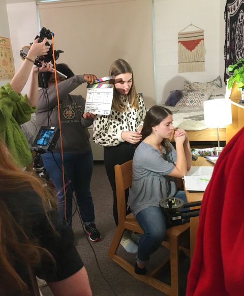 Students shoot film in dorm room.