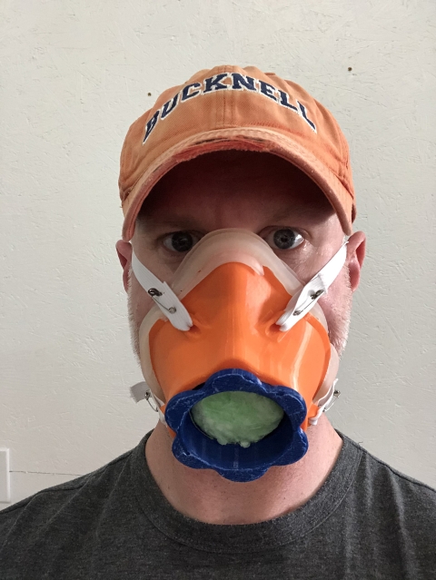 Professor Eric Kennedy, biomedical engineering, models a prototype reuseable mask